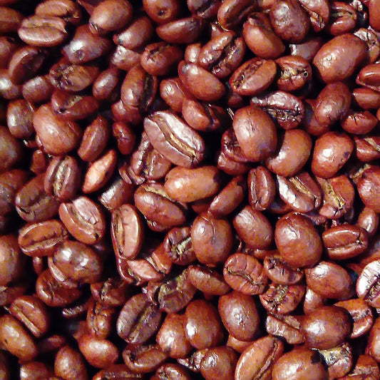 Close-up of roasted Arco Brandy-flavoured Arabica wholebean coffee, highlighting smooth texture and deep roast infused with rich brandy aroma