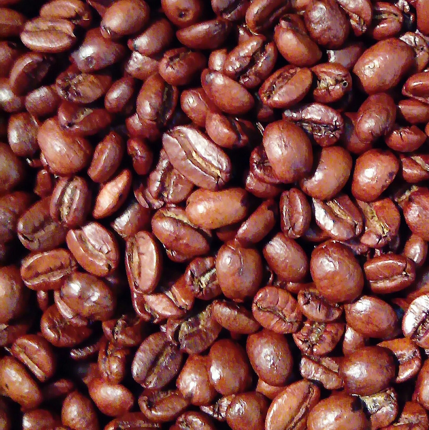 Bag of Arco Orange Brandy-flavoured Arabica wholebean coffee on a wooden surface, surrounded by coffee beans and orange peel, capturing its smooth roast infused with natural orange liqueur flavour